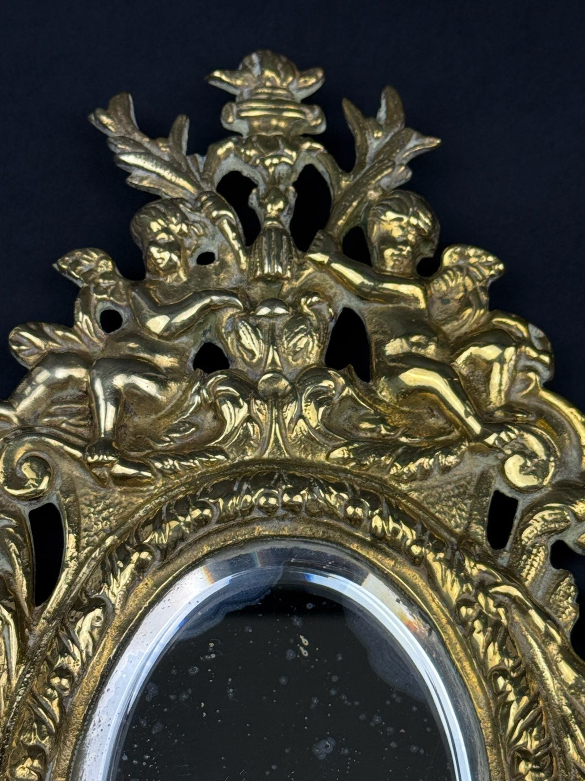 Paire de petits miroirs en bronze à décor de putti